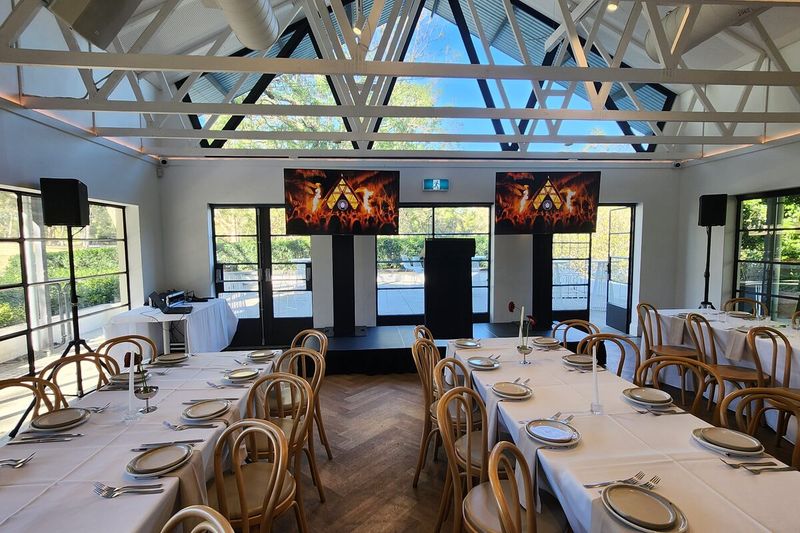 Function room with client branding running on screens either side