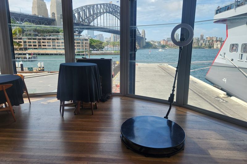 360 booth beside harbourside windows with the Harbour Bridge behind