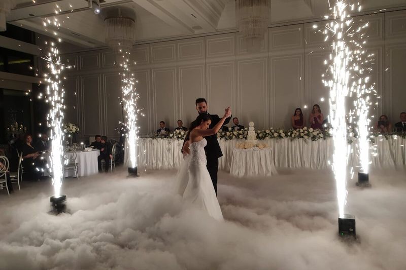 Cold sparkler fountains either side of a couple dancing in a dry ice cloud