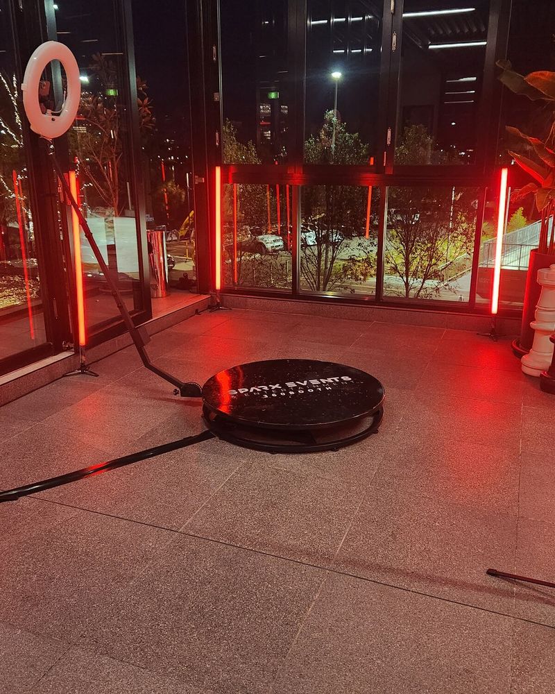 360 spinner platform with red LED tubes set up on a terrace at night