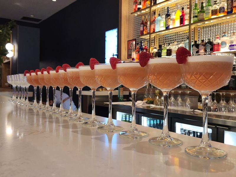 Row of garnished cocktails along the bar
