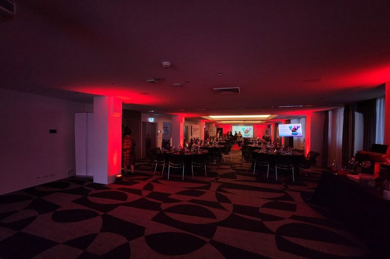 Reception room under a warm red lighting wash