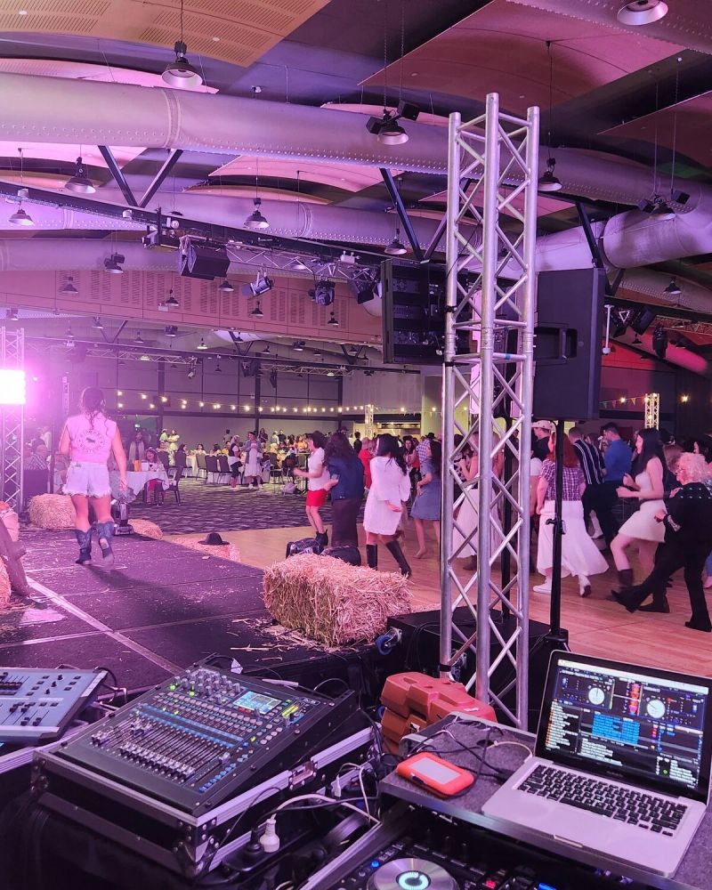 DJ booth and truss lighting rig set up in a function room before guests arrive