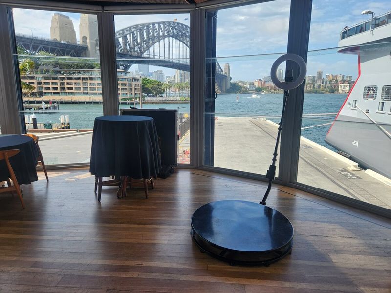 360 booth beside harbourside windows with the Harbour Bridge behind