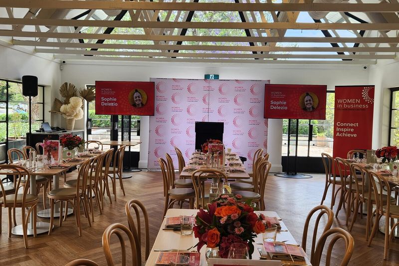 Event stage flanked by branded banners in a ballroom
