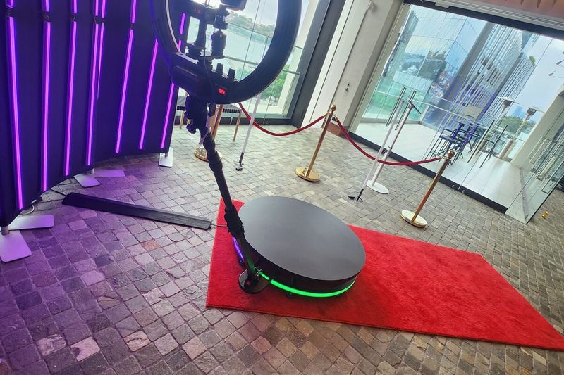 360 booth platform with a red carpet entry and rope barrier