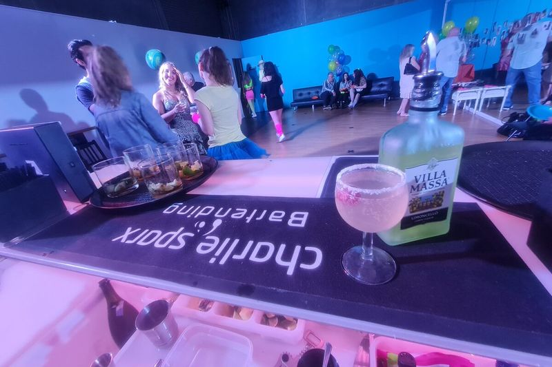 Glow bar set with glassware and garnish, guests behind